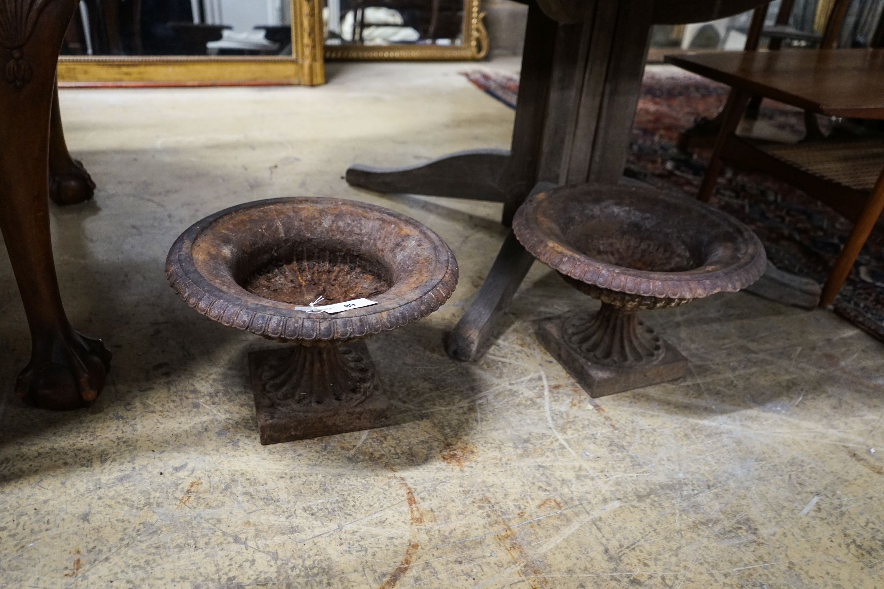 A pair of Victorian cast iron campana garden urns, diameter 38cm, height 25cm